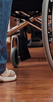 Feet, wheelchair and nurse for help, floor or care in house for support, wellness or recovery for injury. Patient, caregiver or person with disability in nursing home, rehabilitation and mobility aid