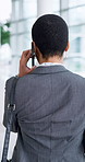 Phone call, walking and back of business woman in discussion, talking and networking in office hallway. Corporate, professional and person on smartphone for conversation, communication and contact