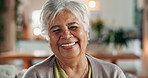 Senior woman, face and happy for retirement in home, comfort and security for future. Elderly person, smile and portrait in living room for relax, wellness and mortgage freedom or pride in Colombia