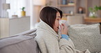 Sick, relax and woman blowing nose in home for flu, cold or sinus infection with allergies. Illness, blanket and person with tissue for sneeze with hayfever or virus recovery in living room at house.