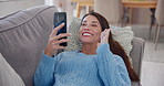 Girl, video call and smartphone with wave for greeting, talking and communication in living room or home. Woman, tech and happiness for conversation, online networking and connection in mobile app