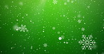 Christmas, particles and snowflakes on green background space for digital card, creativity or festive season. Snow animation, bokeh spots and glitter on wallpaper for texture, sparkle and celebration