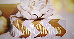 Merry Christmas, gift or sparkle in text for giving, celebration and seasons greetings. Wallpaper, golden and ribbon on package for present, festive holiday and traditional invitation or digital card