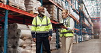 Logistics, man and woman in warehouse with online checklist for digital export distribution. Inventory, planning and team walking in factory together for project management discussion with tablet