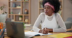 Girl, writing and studying with laptop, notebook and assignment for scholarship or research in home. Black woman, technology and notes for e learning for development, education and support as student