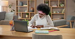 Black woman, writing notes and student reading book in home for study or online education on laptop. University, exam and girl elearning on computer for research, science or biology test preparation