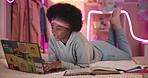 Laptop, black woman and student typing in bed, reading book and studying with neon light. Education, night and girl elearning on computer for knowledge or research for college entrance test in home