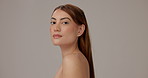 Skincare, cosmetic and face of woman in studio with natural, glow and hydration treatment. Portrait, beauty and person from Thailand with dermatology routine for facial elasticity by gray background.