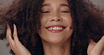 Woman, curly hair care and face in studio with smile, results and excited for growth by background. Person, model and happy for portrait, change and transformation with afro for beauty in Colombia