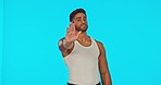 Face, stop hands and man in studio isolated on a blue background for protest, warning or rejection. Portrait, palm and hand of serious male with no gesture to racism, discrimination or inequality.