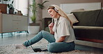 Woman, home and thinking on laptop with headphones for research with music in living room as blogger. Female person, freelance writer and remote work on website for lifestyle article and content