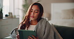 Woman, home and tired on tablet with blanket on couch for browsing social media and internet.Female person, house and exhausted or sleepy in bedroom on sofa for online communication and networking