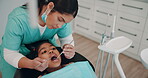 Woman, dentist and kid with dentures for oral care,  teeth hygiene and treatment or removal. Doctor, patient and above on consultation for extraction at medical clinic on canal procedure or surgery