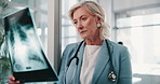 Mature woman, radiologist or exam with x ray for CT scan, test or medical results at hospital. Female person, doctor or healthcare employee checking MRI for anatomy, analysis or examination at clinic
