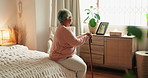 Back, senior woman and relax in bedroom of thinking, nostalgia memory and partner loss for retirement. Elderly person, relax and walking stick for support, picture frame and remember past at house