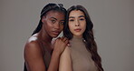 Serious, women and face with skincare in studio for cosmetic, treatment or solidarity on gray background. Confident, friends and people with hug for facial results dermatology shine or natural beauty