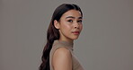 Woman, face and skincare with pride in studio for dermatology, facial shine and satisfaction. Confident, female person  and relax with glow for treatment, results and cosmetics on gray background