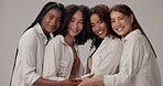 Friends, face and diversity in studio for beauty, solidarity and bonding together with hug, unity and trust. Women, support and inclusion on white background for natural, empowerment and confidence