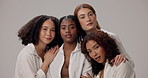 Women, face and diversity in studio for beauty, solidarity and bonding together with hug, unity and love. Friends, support and inclusion on white background for natural, empowerment and confidence