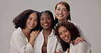 Women, face and solidarity in studio for beauty, diversity and bonding together with hug, unity and group. Friends, support and inclusion on white background for natural, empowerment and confidence