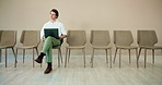 Waiting room, man and thinking with laptop for job interview, vacancy process and business hiring. Chairs, candidate or prepare with online cv for creative agency, recruitment or designer opportunity