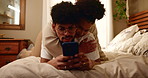 Couple, romance and hugging on bed with phone for social media post, streaming subscription and embrace in home. People, happy and relax with smartphone for online scroll, watching videos and bonding