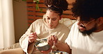 Couple, eating and breakfast on bed in bedroom for nutrition, healthy meal or bonding on holiday. Morning, people and food in home with porridge, talking or relax for wellness, brunch or conversation