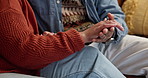 Love, holding hands and couple on sofa in home with support, comfort and empathy. Care, marriage and closeup of man and woman with connection for commitment, security or bonding together at house.