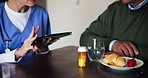 Tablet, hands and nurse with pills for patient eating breakfast in home for healthcare. Drugs, medical and caregiver with medicine bottle for prescription and explain supplement to help sick person