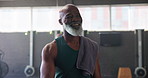 Mature man, walk and happy in gym ready for exercise, workout or training with self care. Confident, smile and satisfied or proud with routine for fitness, wellness or wellbeing for retirement health