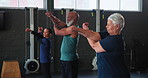 Elderly people, stretching and class in gym with training for fitness, warm up and healthy body. Serious, group and exercise with flexibility in preparation for retirement, workout, and wellness