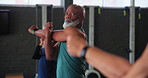 Senior people, stretching and group in gym with fitness for exercise, warm up and healthy body. Serious, class and man training with flexibility in preparation for retirement, wellness and workout