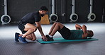 Exercise, trainer and helping senior man with sit ups in gym for retirement wellness, core strength and healthy body. People, instructor and workout support in sports club for performance or training