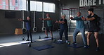 Coach, senior group and squat for exercise in gym with people for muscle development at club in retirement. Person, elderly men and women with weightlifting for workout, training or fitness in class