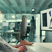 Leg prosthetic or woman on computer for research, inclusive device or ...