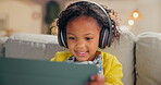 Girl, child and tablet for learning in home, online education and listening to podcast for study. Female person, kid and playing games in living room for mind development, happy song and streaming