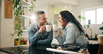 Couple, laughing and drinking coffee with cheers in home for celebration, happy and funny conversation in kitchen. People, toast mug and bonding with beverage in house for support and congratulations