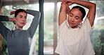 Women, group and stretching at yoga club for wellness, muscle and peace in studio with mindfulness, People, friends and warm up with arms for pilates, health and solidarity in morning at class