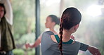 Woman, back and stretching arms at yoga club for wellness, muscle and peace in studio with mindfulness, People, friends and warm up with group for pilates, health and solidarity in morning at class