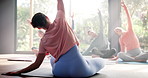 Yoga, instructor and group with stretching in studio for flexibility, holistic wellness and body balance on floor. Back, trainer and pilates with technique for fitness, mindfulness and spiritual zen