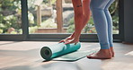 Woman, legs and yoga with mat on floor for pialtes, exercise or indoor workout at home. Female person, hands or yogi rolling training mat for start, warm up or getting ready to stretch at health club