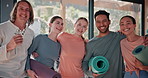 Happy people, yoga and friends with hug for fitness, workout or indoor training together at gym. Portrait, young and yogi group with smile or mat for community, wellness or exercise at health club