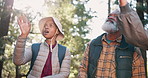 Talking, senior or friends hiking in woods for outdoor adventure or journey for travel in nature or forest. Group, view and old people on path for holiday retirement, walking or trekking to explore