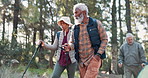 Stick, senior or friends on trail hiking for outdoor adventure or travel in nature, park or forest. Group, talking and elderly people in woods for holiday retirement, walking or trekking to explore