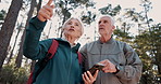 Senior couple, smartphone and hiking with point, location or search for path, landmark and talking in forest. Mature man, woman and trekking with phone, lost and check digital map on app in Italy