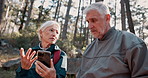 Senior couple, smartphone and lost with hiking, direction or search for path, landmark and talking in forest. Mature man, woman and trekking with phone, question and check digital map on app in Italy