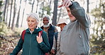 Pointing, senior or friends on trail hiking outdoor adventure or journey for travel in nature or forest. Group, talk and elderly people in woods for holiday retirement, walking or trekking to explore