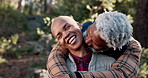 Hugging, happy and senior black couple in nature on vacation, holiday or getaway together. Marriage, love and elderly African man and woman embracing for bonding, care and commitment outdoor on trip.