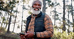 Hiking, smartphone and black man with face, typing and happiness with, digital app and hobby. African person, traveling and hiker with cellphone, social media and internet with trees and retirement