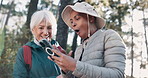 Senior women, friends and phone for hiking, surprise and excited for progress, timer and steps in forest. Mature people, happy and together with smartphone, mobile app and wow for results in Italy